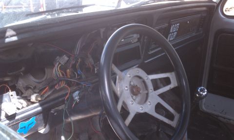 1978 Ford Bronco - Interior view of a car with extensive wiring exposed on the dashboard and center console.