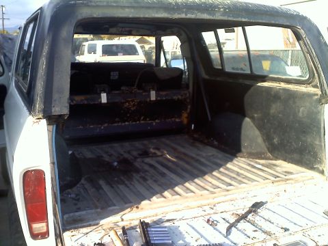 1978 Ford Bronco - View of the truck bed and interior, with another vehicle visible in the background.