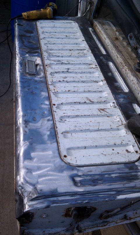 1978 Ford Bronco - The tailgate interior shows signs of wear and tear, with a grinder nearby.