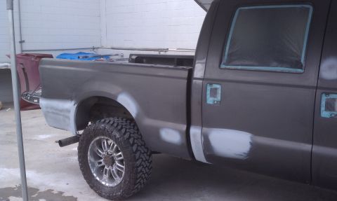 1978 Ford Bronco - Pickup truck undergoing body repairs, with visible primer and sanding on the side panels.