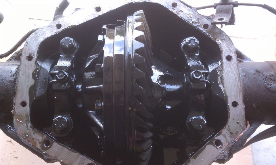 Differential housing with internal gears and bolts visible