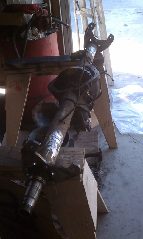 1978 Ford Bronco - Rear axle assembly, likely for a truck or SUV, shown disassembled and supported on wooden blocks.