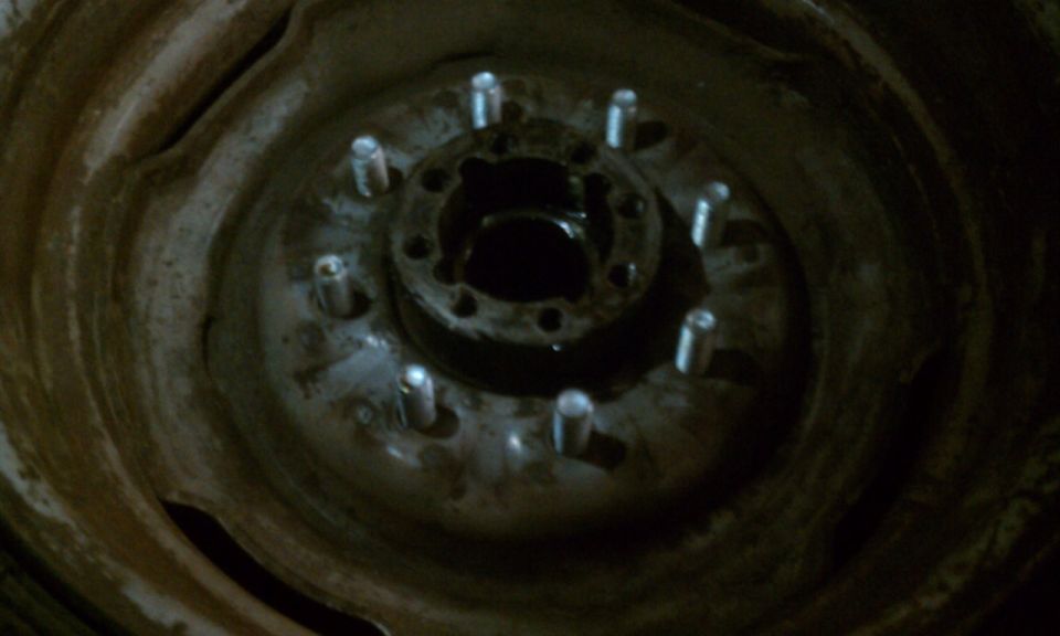 Close-up of a wheel hub with lug bolts visible