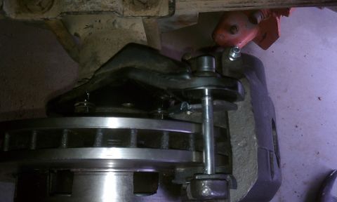 1978 Ford Bronco - This image shows a close-up view of a vehicle's brake system components, including the rotor and caliper.