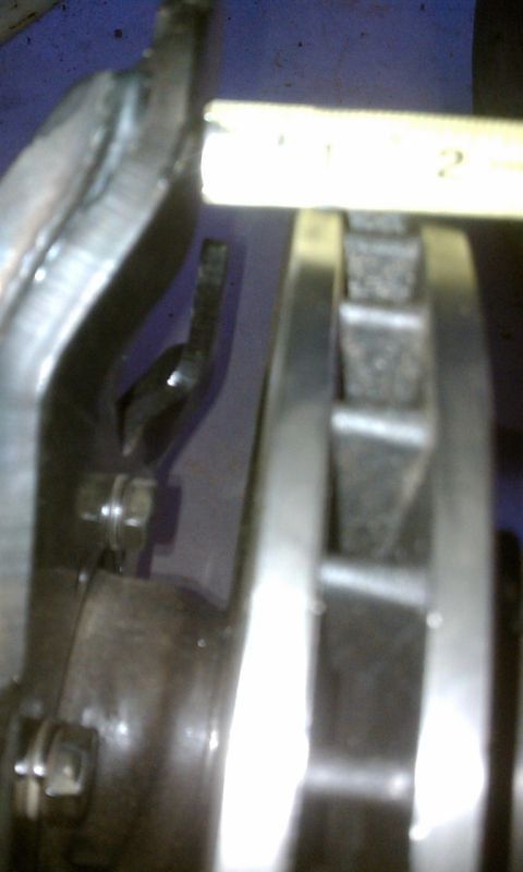 1978 Ford Bronco - Brake rotor and caliper assembly shown with a ruler for measurement.