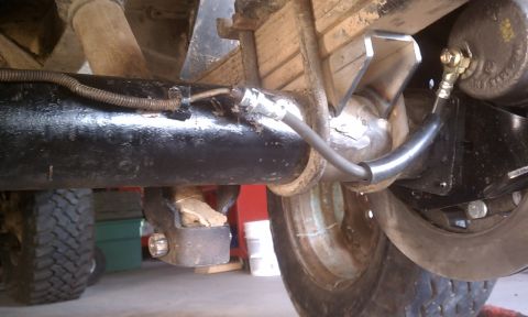1978 Ford Bronco - Close-up view of the undercarriage, focusing on the rear axle and brake system.