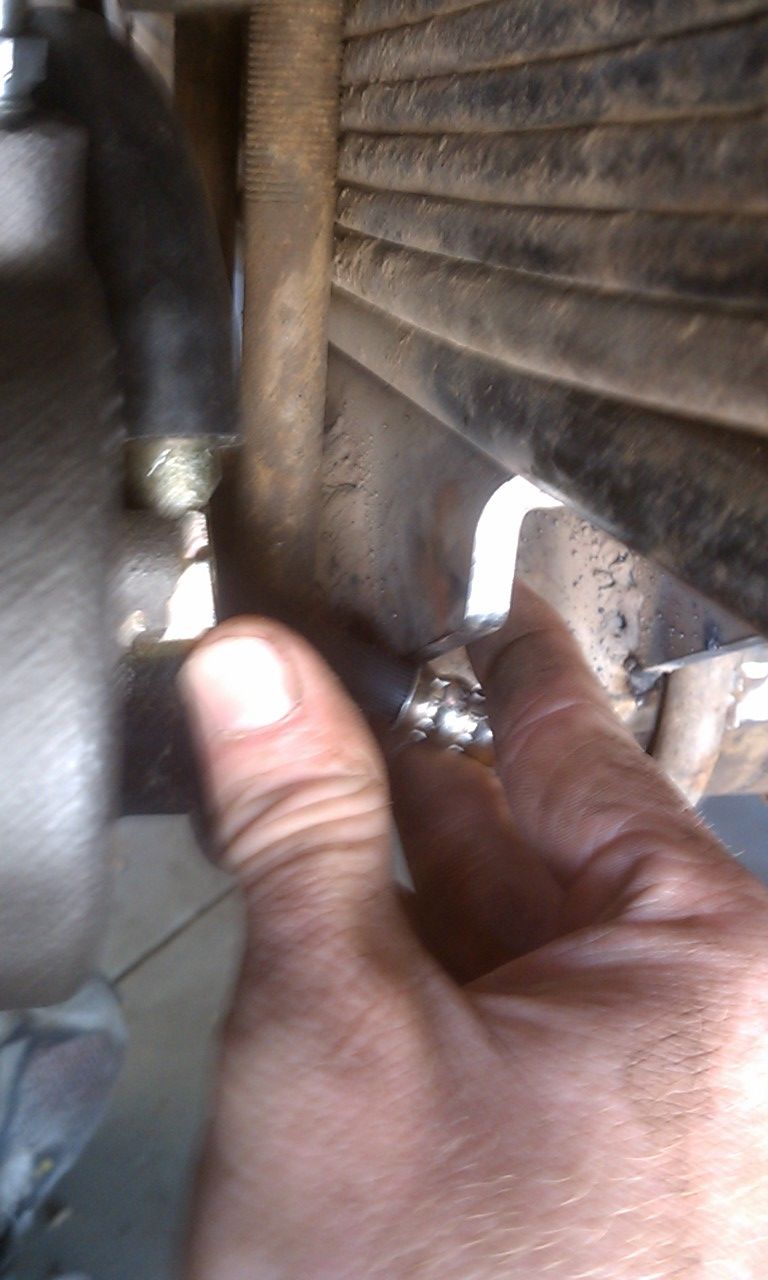 Hand adjusting bolt on leaf spring assembly
