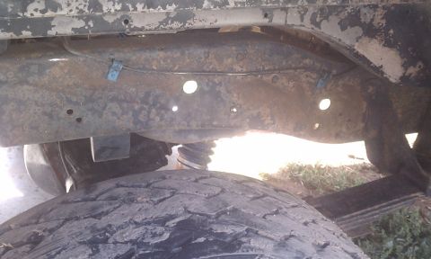 1978 Ford Bronco - Undercarriage view showing the frame and suspension components of a vehicle.