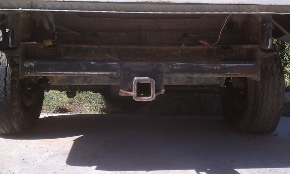rear of a truck with a hitch receiver and tires visible