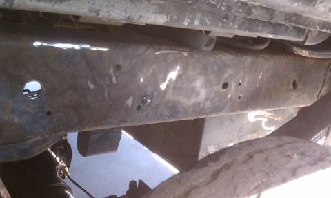 1978 Ford Bronco - Close-up of a corroded vehicle frame, showing signs of repair and wear.
