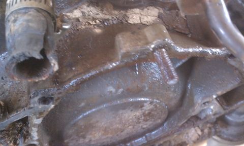 1978 Ford Bronco - A close-up view of a corroded engine component, possibly from a radiator system.