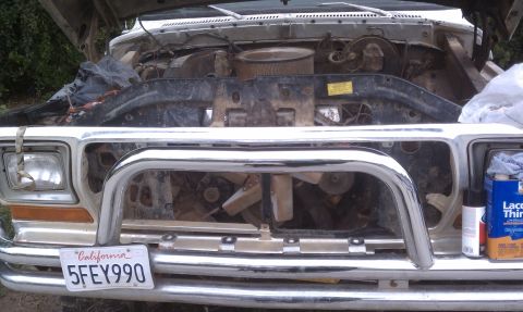 1978 Ford Bronco - Front view of a 1978 Ford Bronco's engine bay, with the hood up. The radiator and fan are visible.