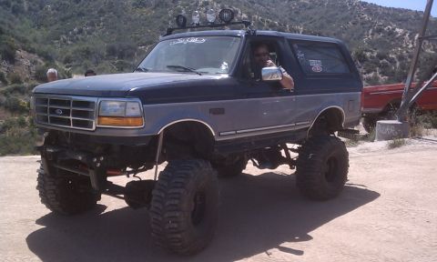 1978 Ford Bronco - Modified Ford Bronco with significant lift and oversized tires parked outdoors.