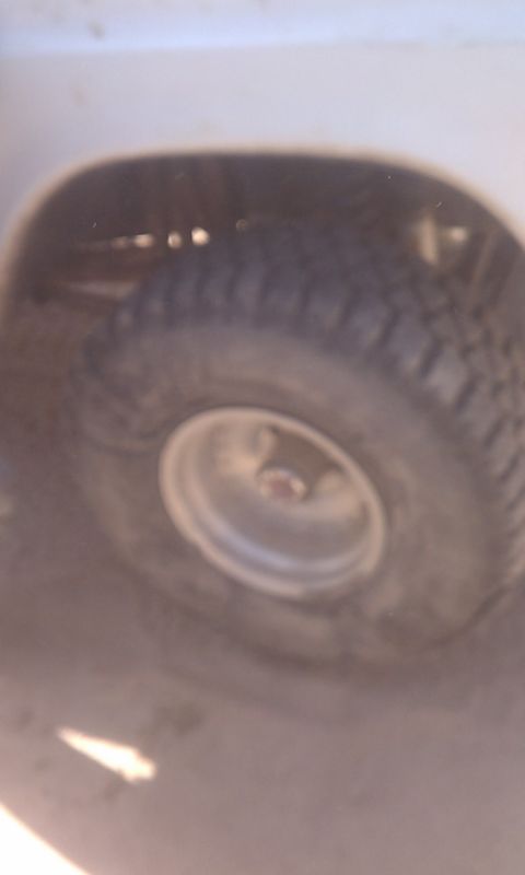 1978 Ford Bronco - A close-up shot focuses on a off-road tire and its wheel, hinting at adventure.