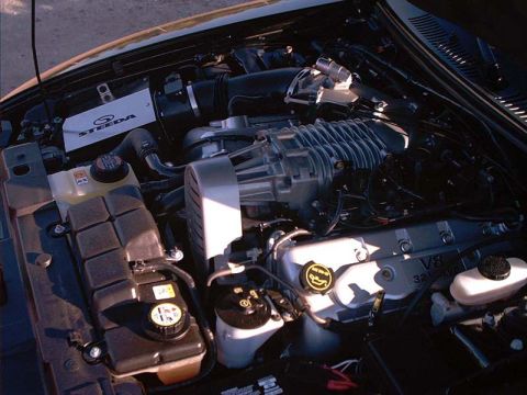 2000 Ford Crown Victoria - Close-up of a modified engine bay a Steeda supercharger and a V8 32 valve engine cover.