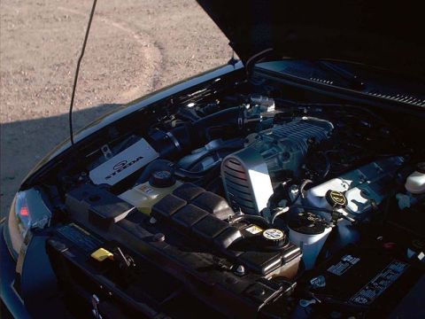 2000 Ford Crown Victoria - Close-up of a modified engine bay, a prominent supercharger and aftermarket air intake system.