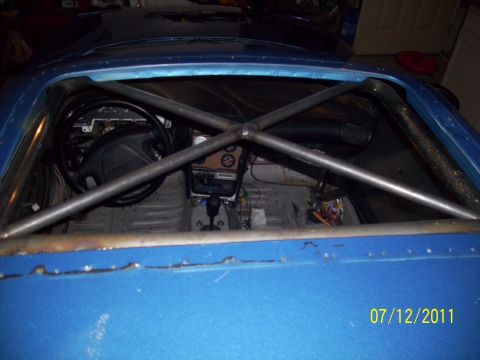1995 Ford Probe - Interior view of a 1995 Ford Probe, showing a custom roll cage and racing modifications.