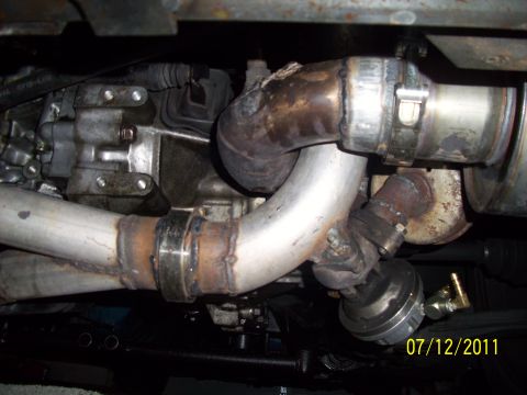 1995 Ford Probe - Underside view of a vehicle's exhaust system, showing custom piping and turbocharger components.