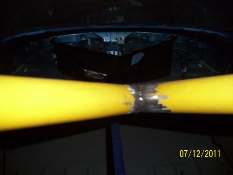 1995 Ford Probe - Welded yellow roll cage bars are visible inside a dark vehicle interior, dated 07/12/2011.