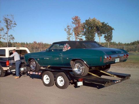 2000 Ford Crown Victoria - A green 1970 Chevelle convertible is loaded onto a trailer, with a Ford Bronco assisting.
