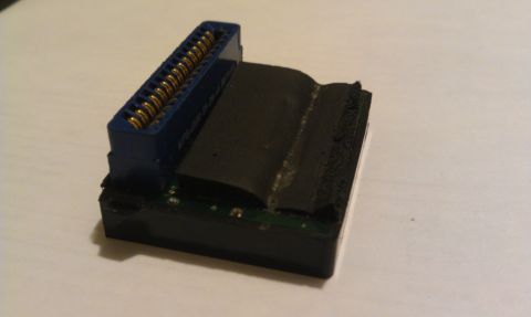 1992 Ford Ranger - Close-up of an electronic connector with a blue housing and gold pins, likely a component part.