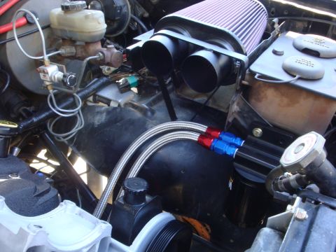 1989 Ford Bronco - Close-up view of an engine bay, highlighting custom modifications like an air intake and oil cooler.