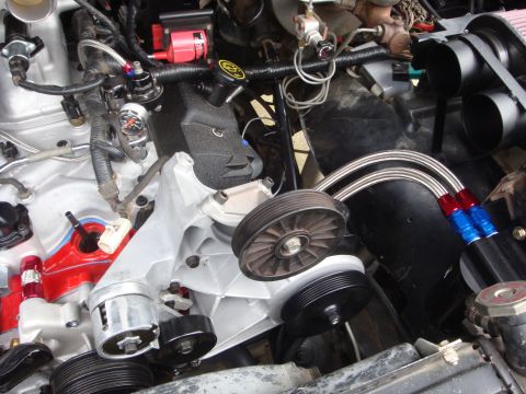 1989 Ford Bronco - Close-up view of an engine bay, highlighting custom fuel lines and engine components.