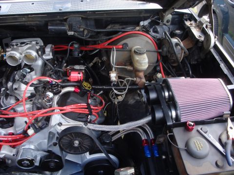 1989 Ford Bronco - A modified engine bay shows custom parts and wiring, with a prominent air filter assembly.