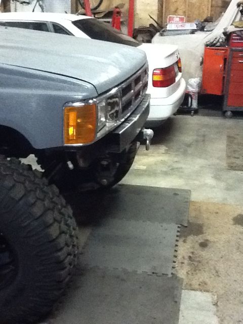 1988 Suzuki Samurai - A gray truck is parked in a garage next to a white car, with a SuperMotors.net watermark visible.