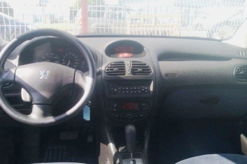 1991 Ford LTD Crown Victoria - The interior of a Peugeot 206 shows the driver's side controls and dashboard.