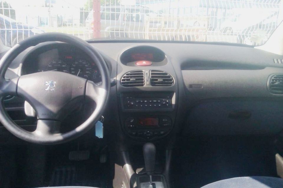 Peugeot 206 interior dashboard with steering wheel, instrument cluster, and center console