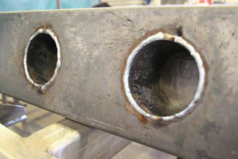 1973 Ford Ranchero - Close-up of a metal component with two holes, likely part of a vehicle frame or chassis.