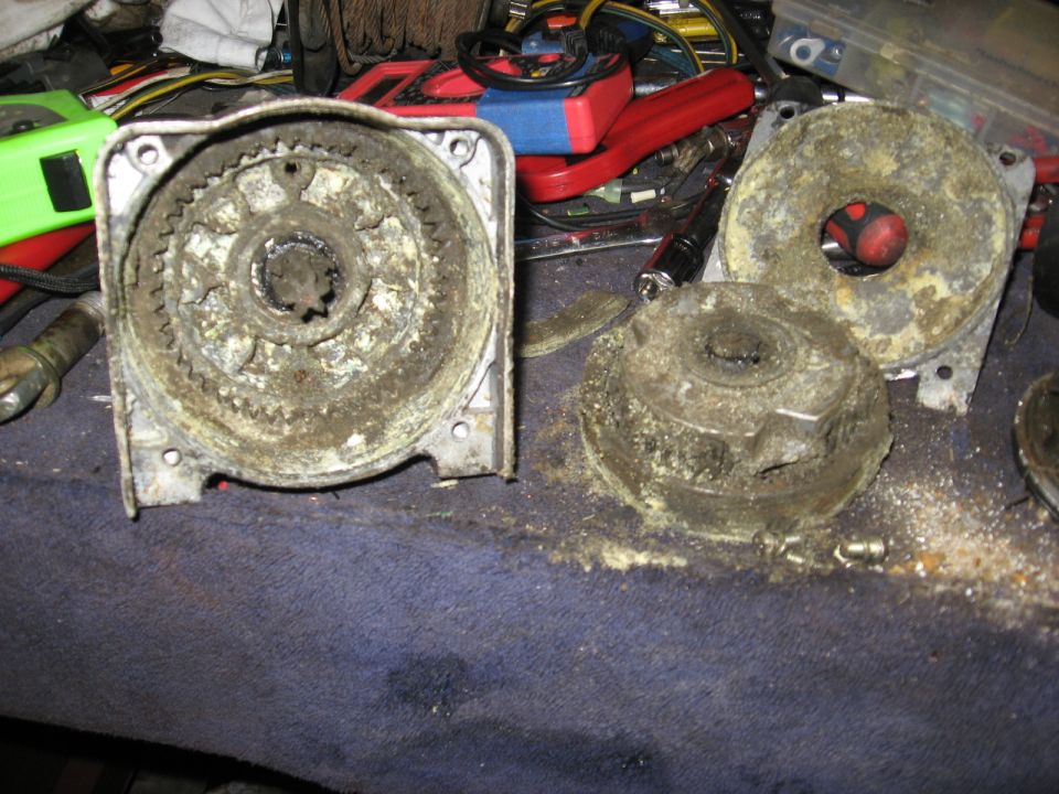 Grease-caked splined hub housing, cover plate and drum laid on blue shop blanket