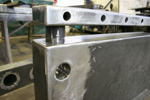 1973 Ford Ranchero - Close-up of fabricated metal components with visible weld marks and drilled holes.
