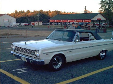2000 Ford Crown Victoria - White 1966 Plymouth Barracuda convertible with black top at a drag strip.