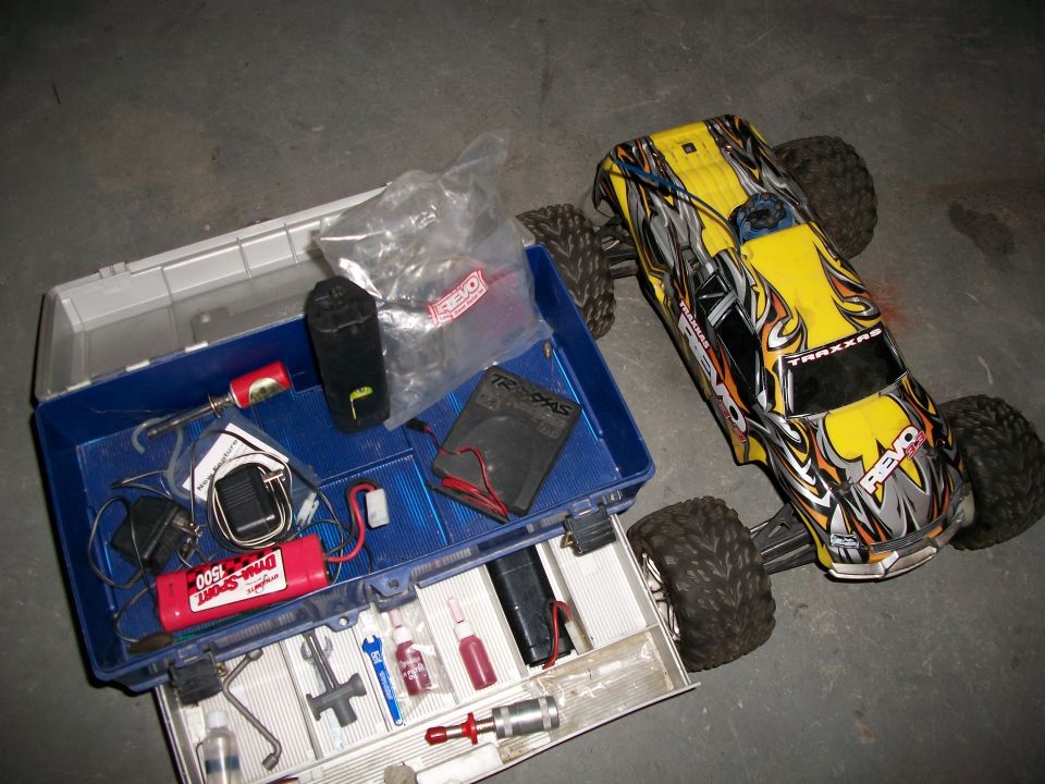 Yellow and black remote control car with toolbox and parts