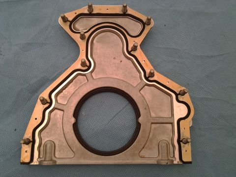 1996 Yamaha RA760 WaveRaider 2-P - This is a close-up view of a metal engine timing cover gasket with a black rubber seal.