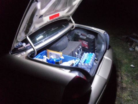 2000 Mercury Grand Marquis - The trunk of a car is open, revealing various items stored inside.