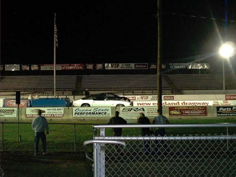 2000 Ford Crown Victoria - Drag cars await the start of a race at New England Dragway under the lights.