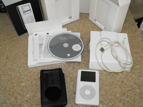1994 Ford Bronco - This photo displays an Apple iPod, its original packaging, software disc, and user manual.