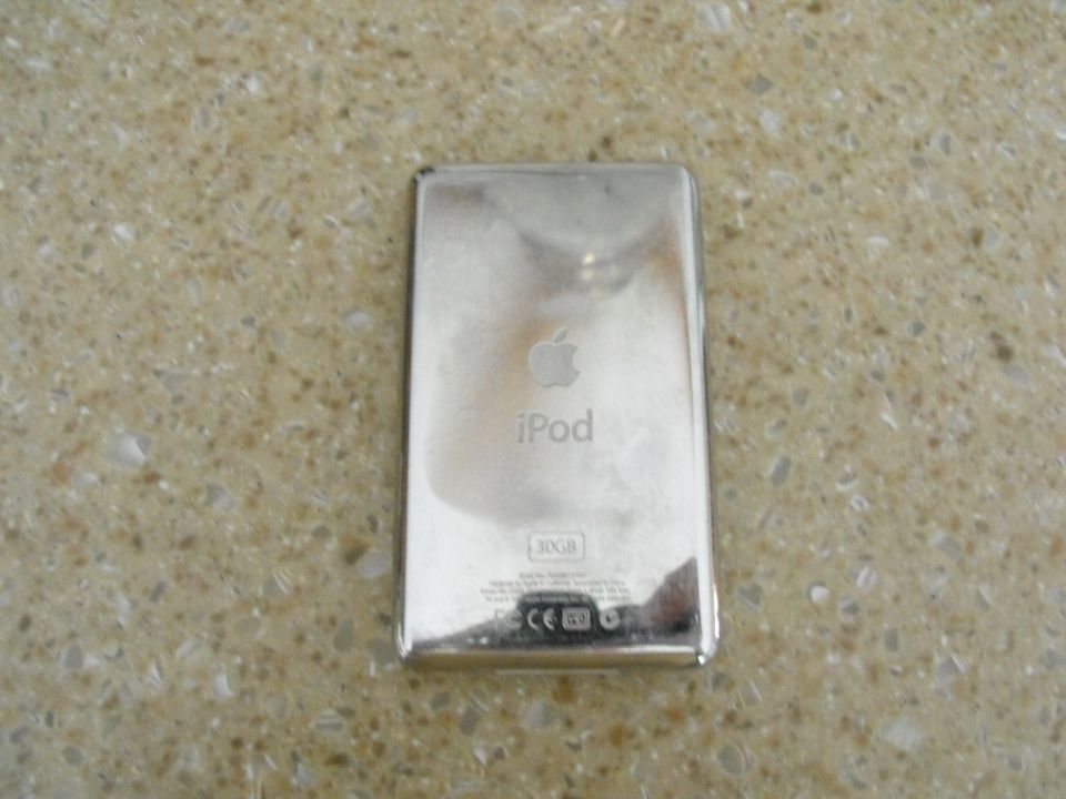 Back of an iPod with Apple logo, 'iPod' text, and '30GB' capacity