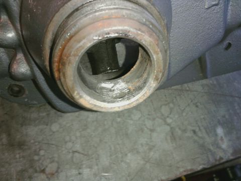 1995 Ford Bronco - A close-up view of a worn metal pipe fitting, showing internal damage and rust.