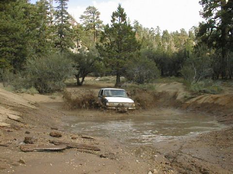 1997 Ford Ranger - Pickup truck navigating a muddy obstacle on an off-road trail.