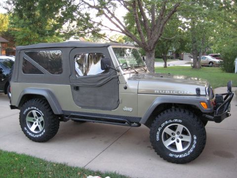2005 Jeep Wrangler - This 2005 Jeep Wrangler is shown from a three-quarter front angle, highlighting its off-road tires and soft top.