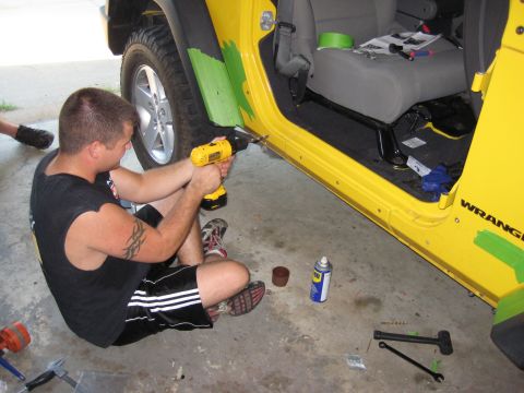 2005 Jeep Wrangler - Working on the door sill of a yellow Jeep Wrangler, likely a 2005 model.