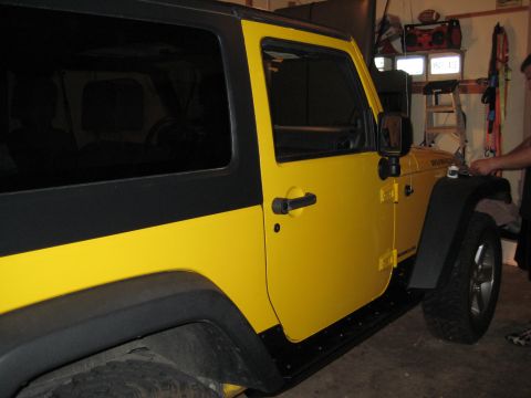 2005 Jeep Wrangler - This yellow Jeep Wrangler, identified by its "Rubicon" badge, is shown from the side in this photo.