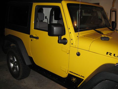 2005 Jeep Wrangler - This yellow Jeep Wrangler features a black hardtop and side decals.