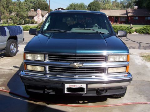 1995 Chevrolet Tahoe - 1995 Chevrolet Tahoe front view, parked outside with another truck nearby.