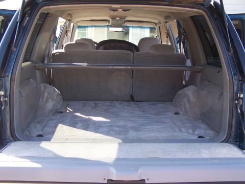 1995 Chevrolet Tahoe - View of the cargo area inside a 1995 Chevrolet Tahoe, showing the rear seats and carpeted floor.