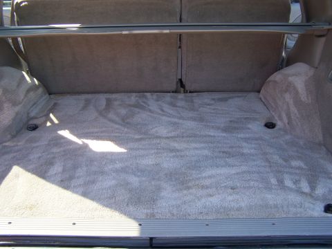 1995 Chevrolet Tahoe - The interior cargo space of an SUV, showing the carpeted floor and folded rear seats.